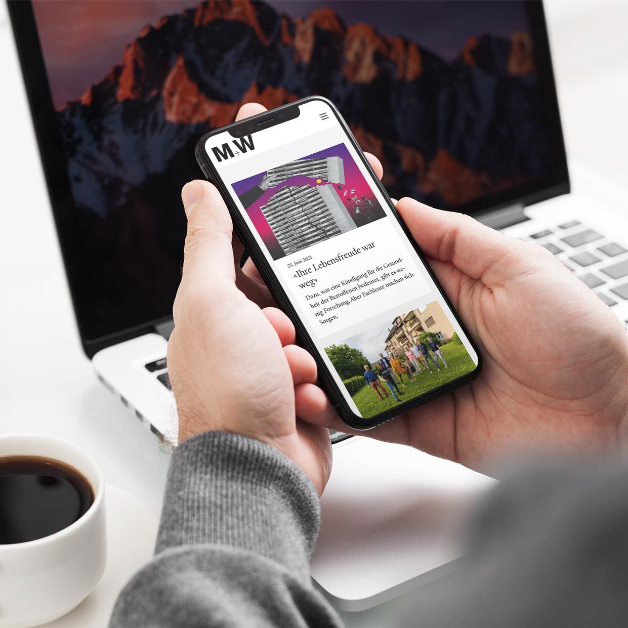 Mann hält Handy und betrachtet die Website Mieten und Wohnen